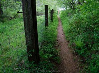 The trail squeezes through two property boundaries