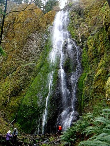 Folks exploring at the base of the falls